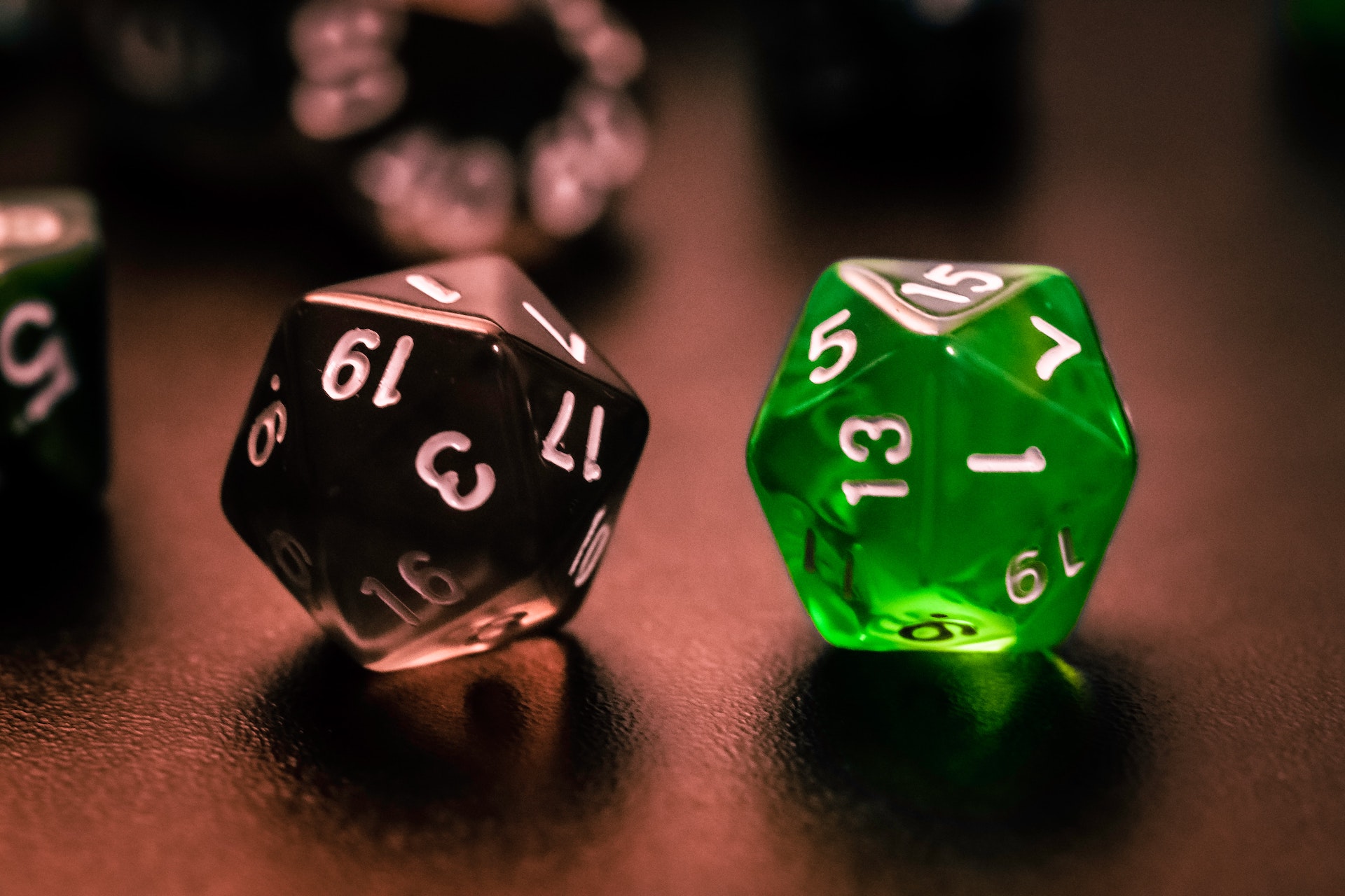 A couple of d20 dice. One black, landed on a one. The other one green, landed on a 15